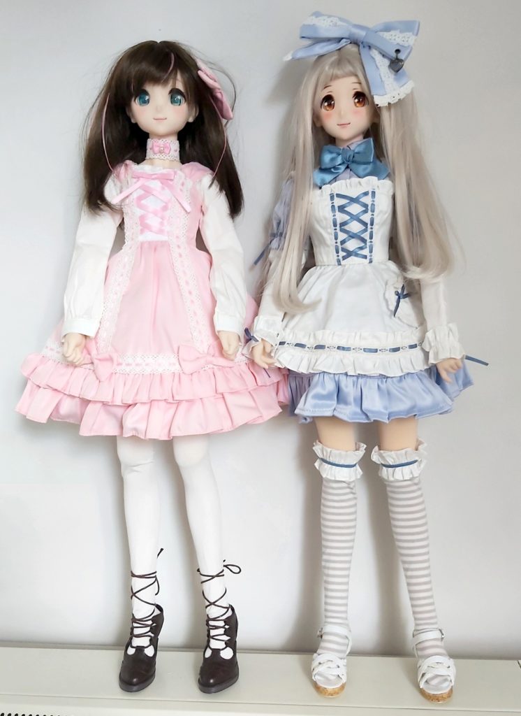 Dollfie Dream vinyl dolls Kizuna AI and Uzuki Shimamura wearing cute pink and blue outfits
