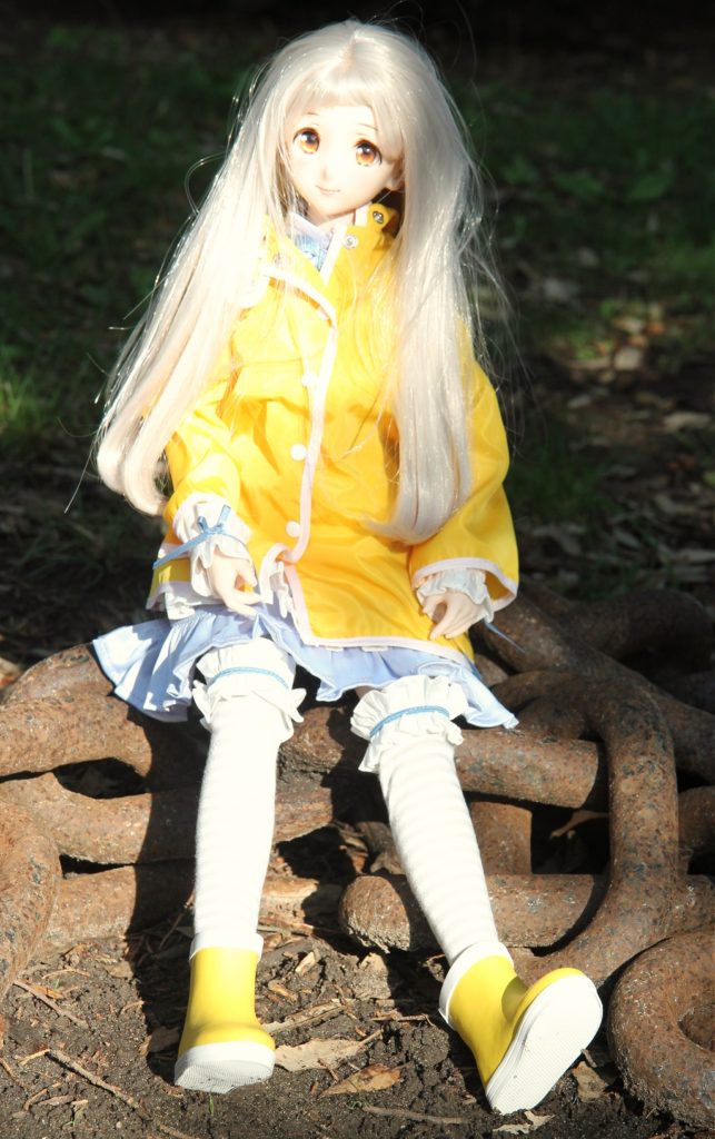 Dollfie Dream doll wearing raincoat and boots